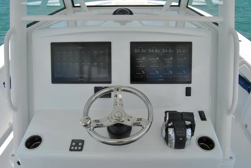 Slide: The Image of 2022 Yellowfin 39 Offshore helm with dual displays and steering wheel. - 19