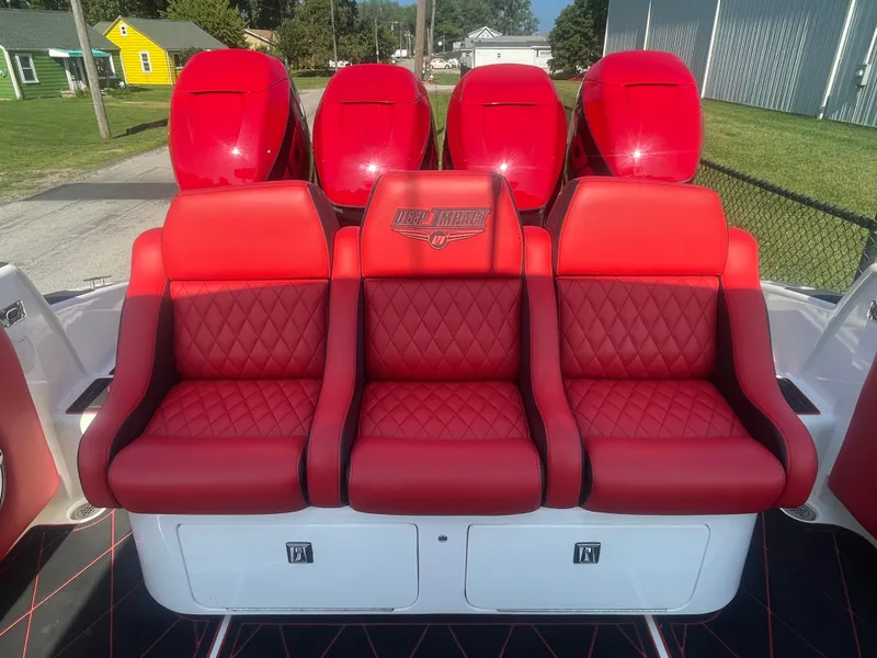 Slide: The Image of Red leather seats on a 2008 Deep Impact 36di boat with triple outboard engines. - 13