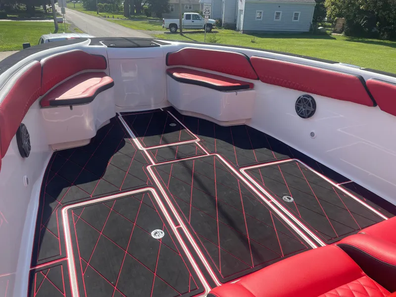 Slide: The Image of 2008 Deep Impact 36di boat interior with red and black seating and flooring. - 14