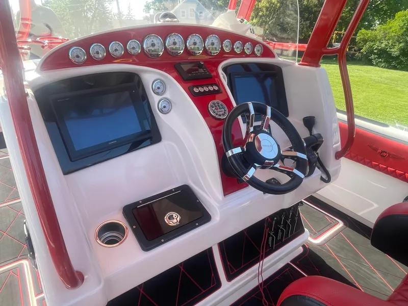 Slide: The Image of 2008 Deep Impact 36di boat dashboard with steering wheel and navigation screens. - 16