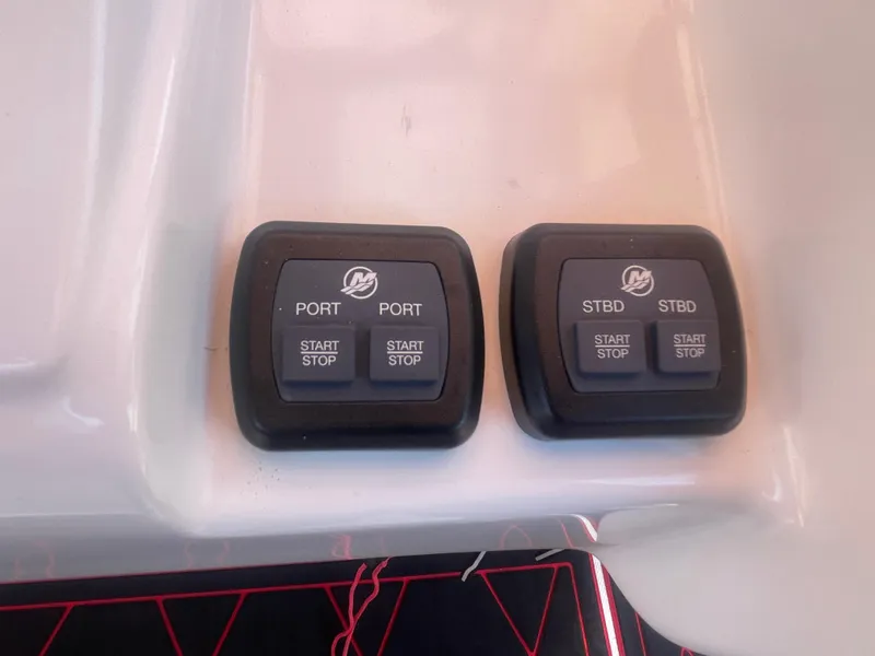 Slide: The Image of Control panel of a 2008 Deep Impact 36di boat with start/stop buttons. - 19