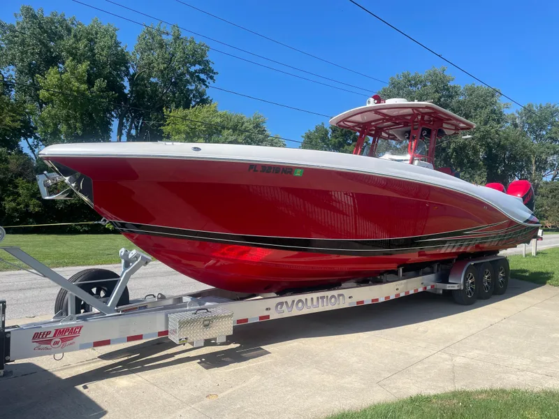 Slide: The Image of Red 2008 Deep Impact 36di boat on a trailer, parked outdoors. - 35