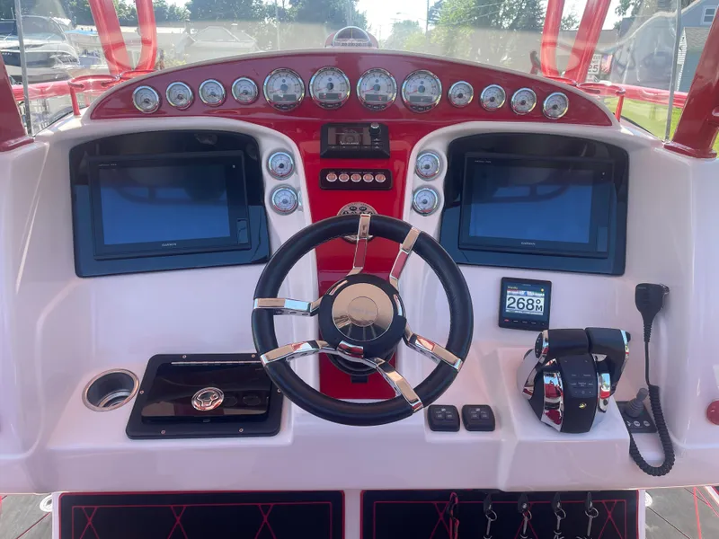 Slide: The Image of 2008 Deep Impact 36di boat dashboard with dual screens and steering wheel. - 36