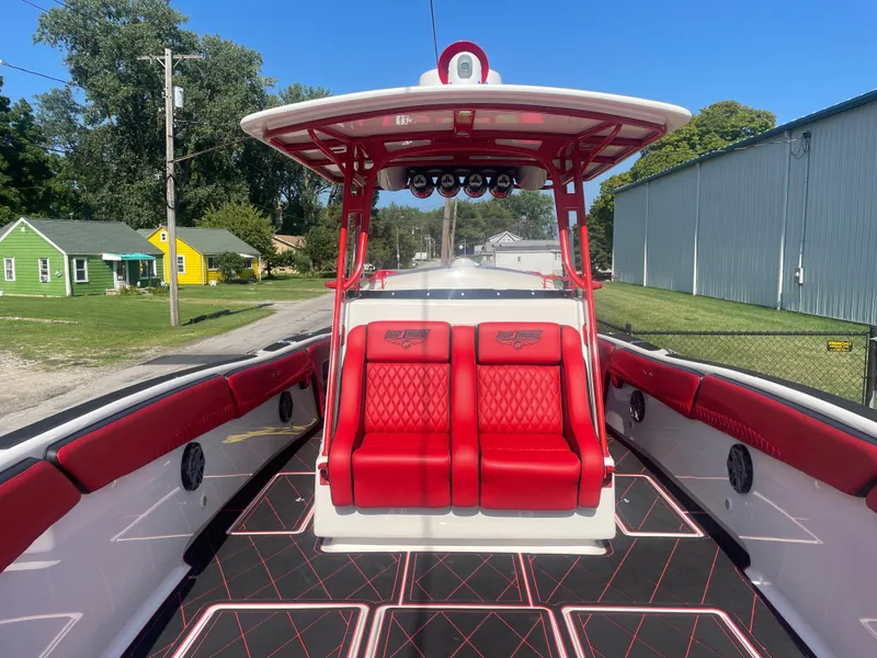 Slide: The Image of 2008 Deep Impact 36di boat with red and white interior, docked near residential area. - 38