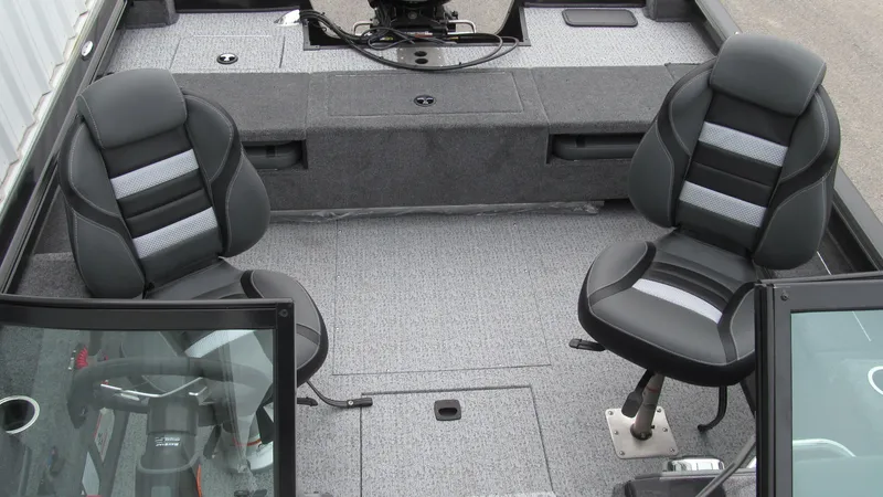 Slide: The Image of 2024 Ranger VS1782SC Reata boat interior with two black seats and gray carpet. - 12