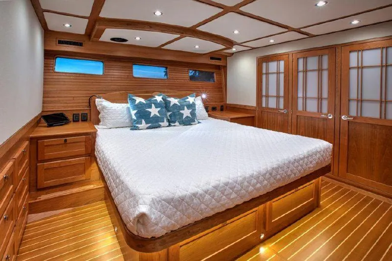 Slide: The Image of Luxurious bedroom interior of 2025 Sabre 58 Salon Express yacht with wooden finishes. - 12