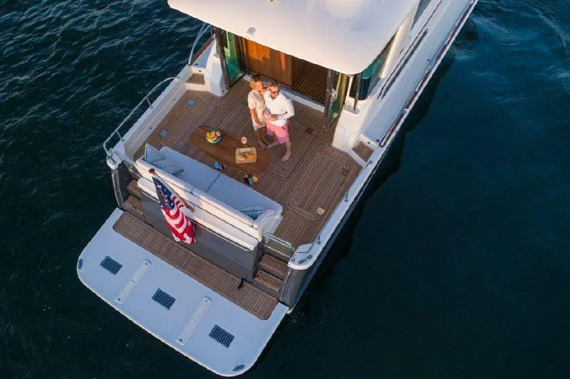 Slide: The Image of Aerial view of a 2025 Sabre 58 Salon Express yacht with a couple on deck. - 4