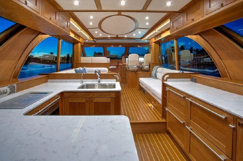 Slide: The Image of Interior of 2025 Sabre 58 Salon Express yacht with modern kitchen and seating area. - 7