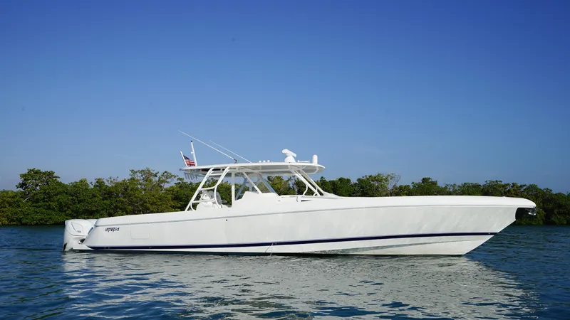 The Image of 2016 Intrepid 475 Panacea boat on calm water with clear blue sky. - 0