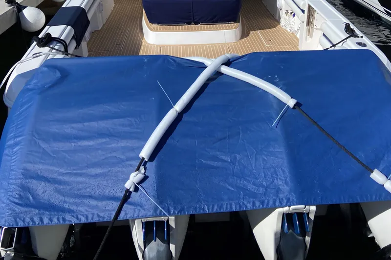 Slide: The Image of 2016 Intrepid 475 Panacea boat with blue cover and wooden deck. - 19
