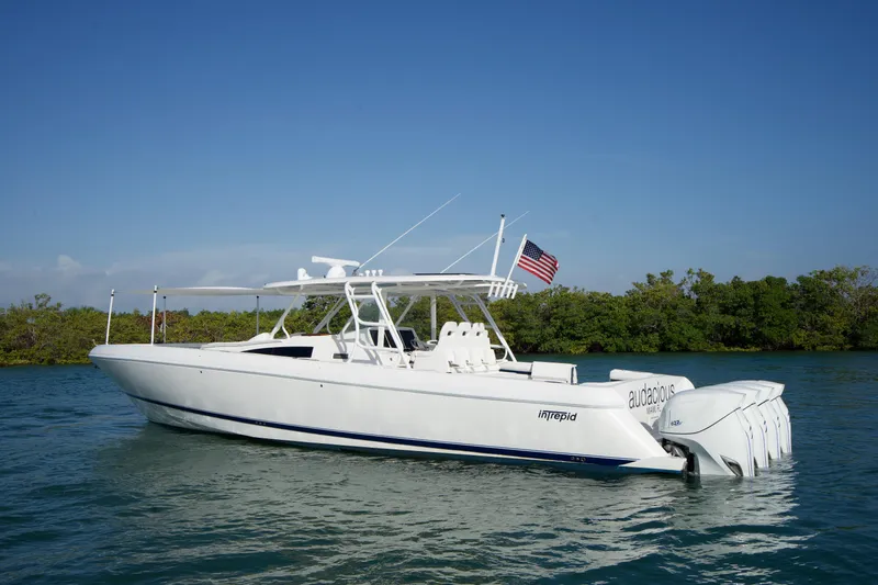 Slide: The Image of 2016 Intrepid 475 Panacea boat on water with American flag. - 2