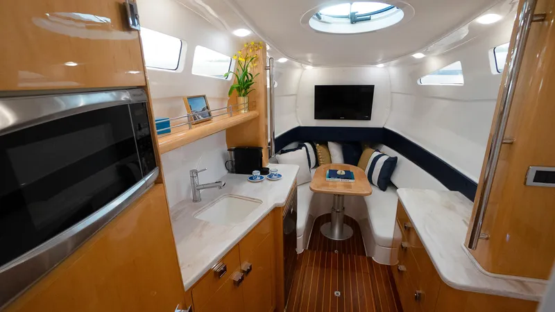 Slide: The Image of Interior of 2016 Intrepid 475 Panacea yacht with modern amenities and cozy seating area. - 21