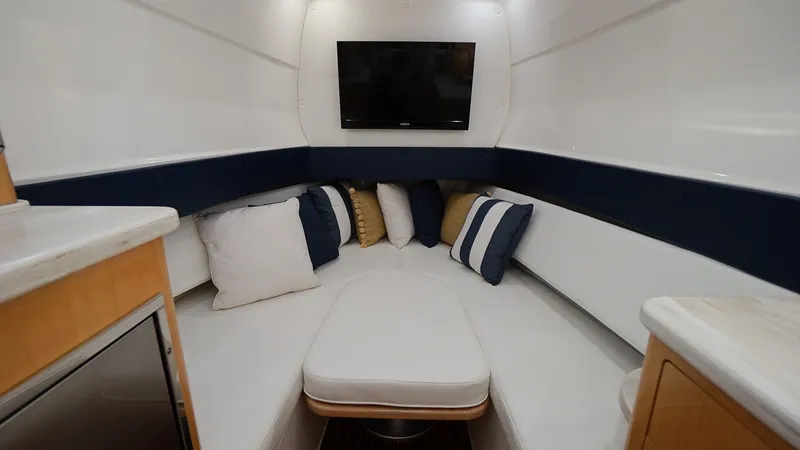 Slide: The Image of Interior cabin of 2016 Intrepid 475 Panacea with seating, pillows, and TV. - 23
