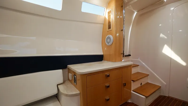 Slide: The Image of Interior of 2016 Intrepid 475 Panacea yacht with wooden cabinetry and seating. - 26