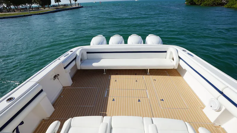 Slide: The Image of 2016 Intrepid 475 Panacea boat with spacious deck and seating, docked on calm waters. - 5