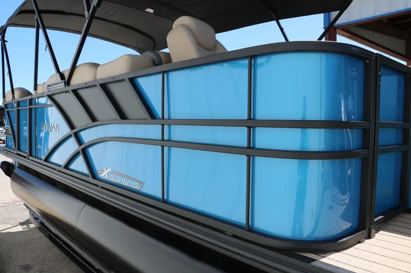 Slide: The Image of 2025 Sylvan Mirage X3 Party Fish pontoon boat with blue and black exterior. - 10