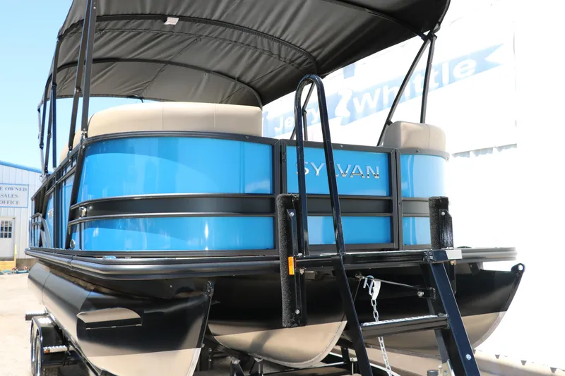 Slide: The Image of 2025 Sylvan Mirage X3 Party Fish pontoon boat, rear view with blue exterior and canopy. - 12