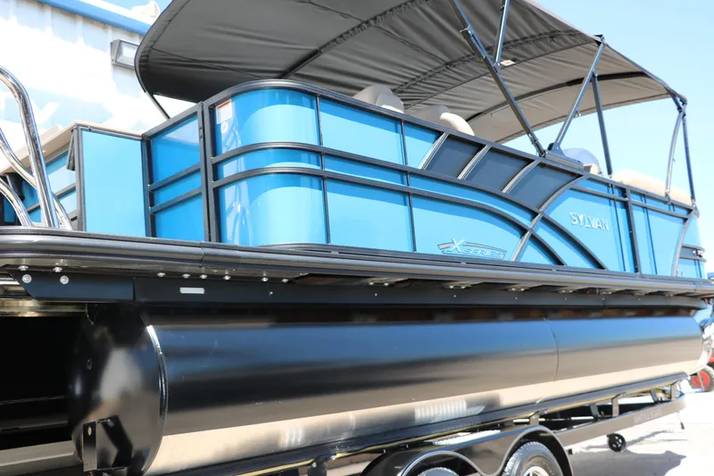 Slide: The Image of 2025 Sylvan Mirage X3 Party Fish pontoon boat with blue exterior. - 2