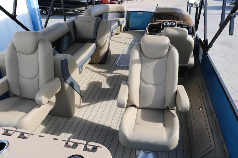 Slide: The Image of 2025 Sylvan Mirage X3 Party Fish pontoon boat interior with beige seating. - 21