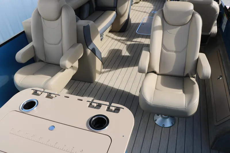 Slide: The Image of 2025 Sylvan Mirage X3 Party Fish boat interior with beige seating and table. - 22