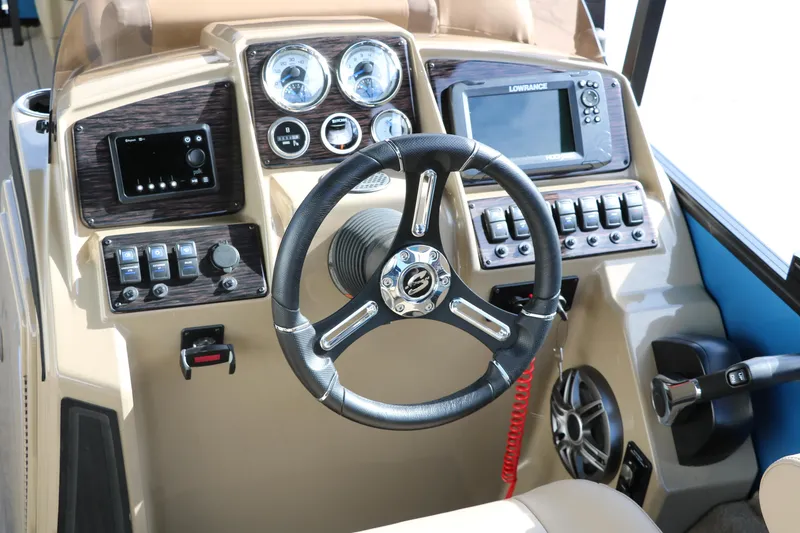 Slide: The Image of 2025 Sylvan Mirage X3 Party Fish boat dashboard with steering wheel and control panel. - 28