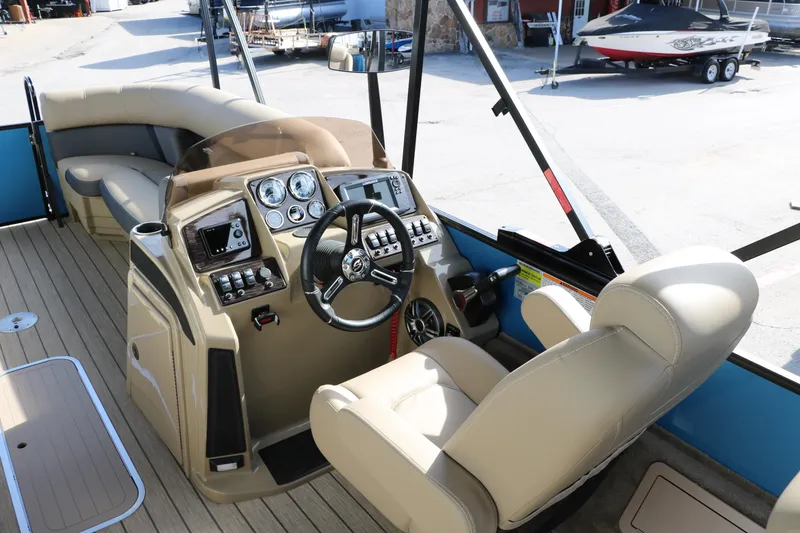 Slide: The Image of 2025 Sylvan Mirage X3 Party Fish boat interior with captain's chair and control panel. - 29