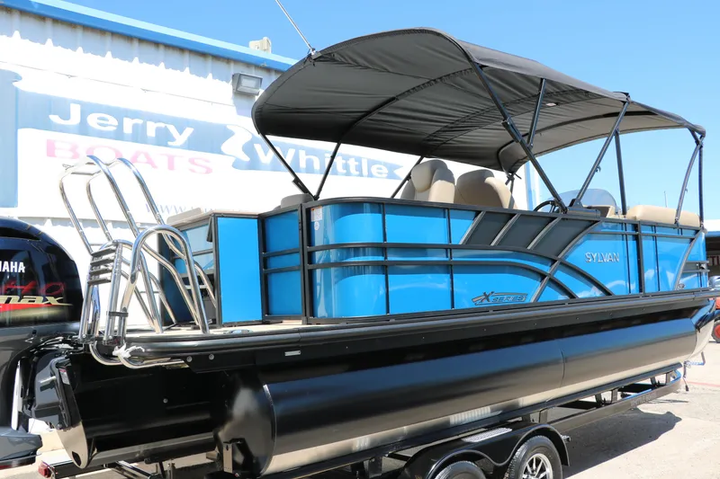 Slide: The Image of 2025 Sylvan Mirage X3 Party Fish pontoon boat in blue and black. - 3