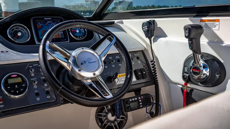 Slide: The Image of 2015 Sea Ray SDX 270 boat dashboard with steering wheel and control panel. - 22