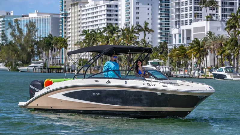 Slide: The Image of 2015 Sea Ray SDX 270 boat cruising near city waterfront. - 25