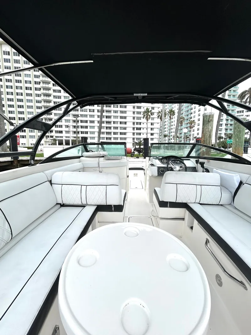 Slide: The Image of 2015 Sea Ray SDX 270 boat interior with white seating and black canopy. - 31