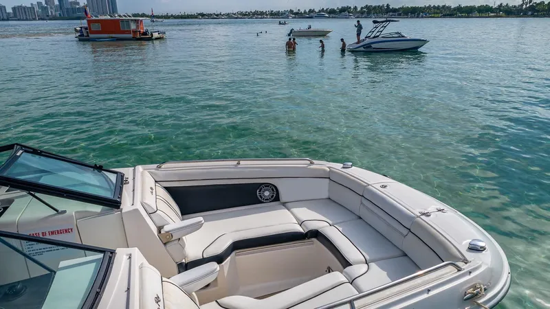 Slide: The Image of 2015 Sea Ray SDX 270 boat on clear water with city skyline in background. - 6