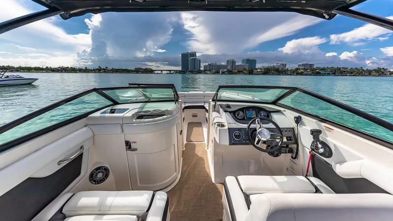 Slide: The Image of 2015 Sea Ray SDX 270 boat interior with waterfront cityscape in the background. - 7