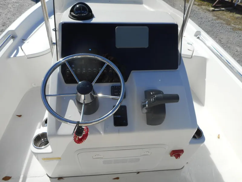Slide: The Image of 2024 Bulls Bay 2000 boat console with steering wheel and controls. - 3