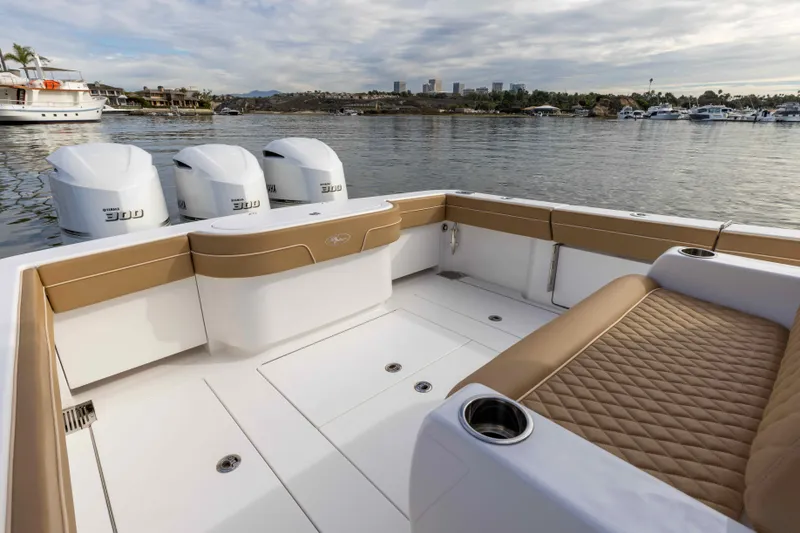 Slide: The Image of 2021 Valhalla Boatworks V37 with triple outboard engines on a calm lake. - 10