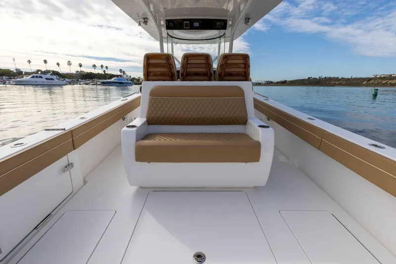 Slide: The Image of 2021 Valhalla Boatworks V37 interior with tan seating and open deck. - 11