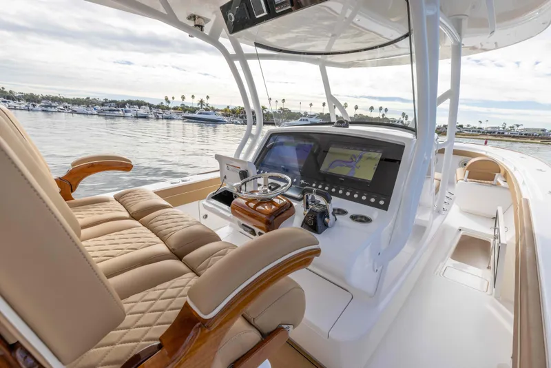 Slide: The Image of 2021 Valhalla Boatworks V37 helm station with luxurious seating and advanced navigation systems. - 12