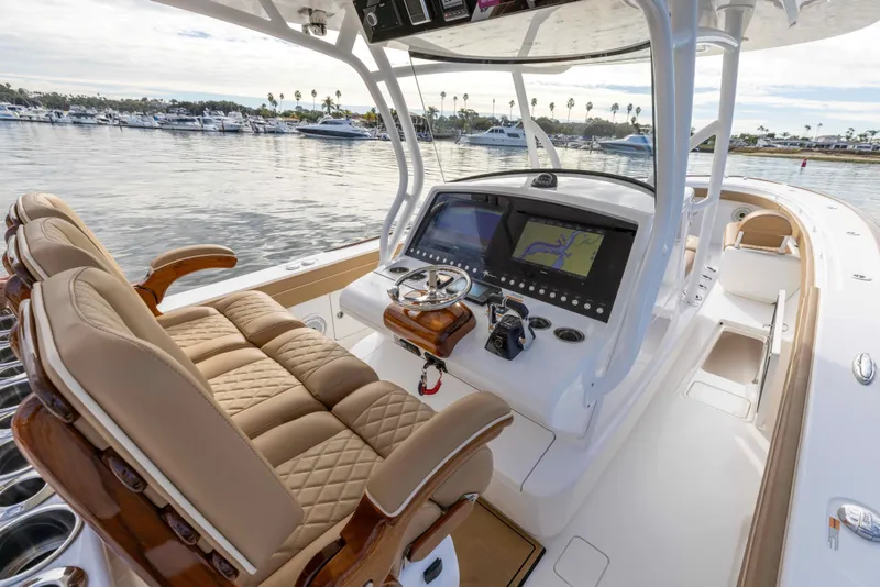 Slide: The Image of 2021 Valhalla Boatworks V37 helm station with luxurious seating and advanced navigation systems. - 13