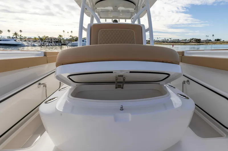 Slide: The Image of 2021 Valhalla Boatworks V37 with open storage compartment and cushioned seating. - 17