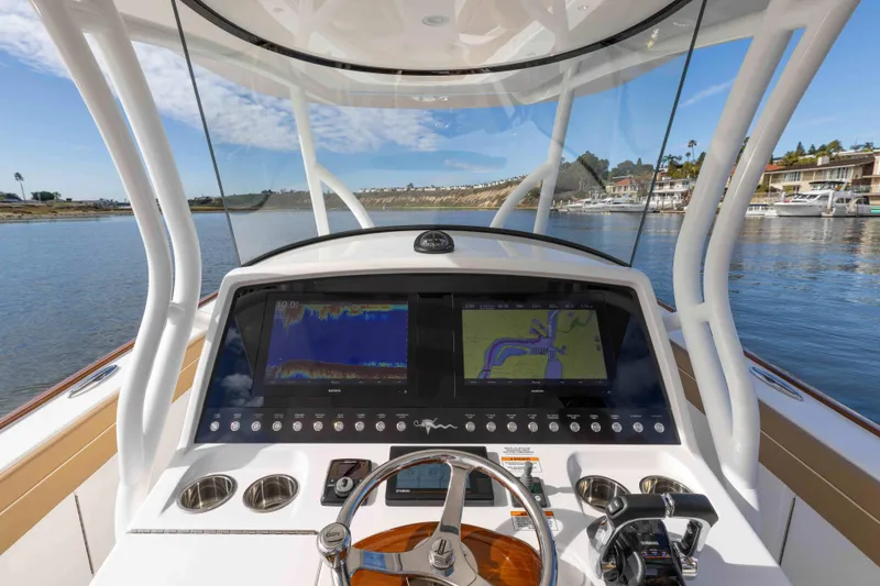 Slide: The Image of 2021 Valhalla Boatworks V37 helm with dual navigation screens and waterfront view. - 19