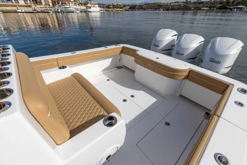 Slide: The Image of 2021 Valhalla Boatworks V37 with tan seating and quad engines on a calm waterway. - 20