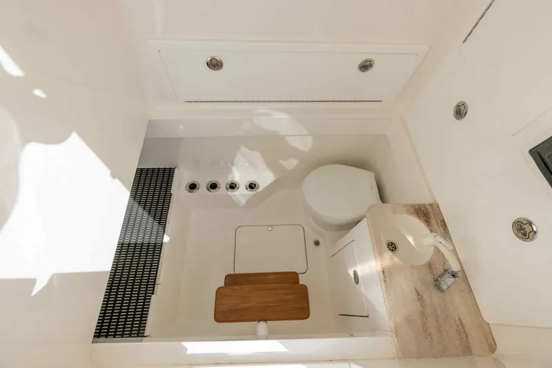 Slide: The Image of 2021 Valhalla Boatworks V37 bathroom with toilet, sink, and storage compartments. - 22