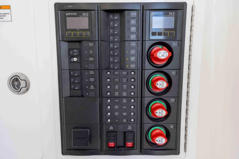 Slide: The Image of 2021 Valhalla Boatworks V37 electrical control panel with switches and displays. - 23