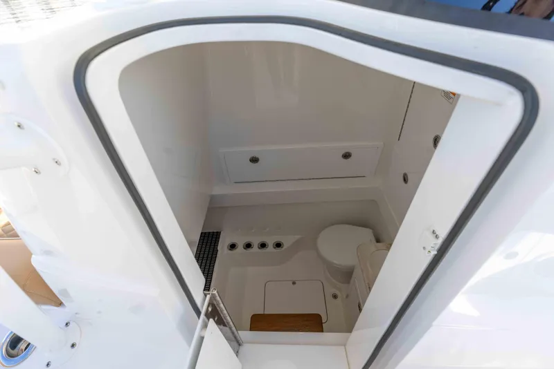 Slide: The Image of 2021 Valhalla Boatworks V37 interior bathroom with toilet and storage compartments. - 26