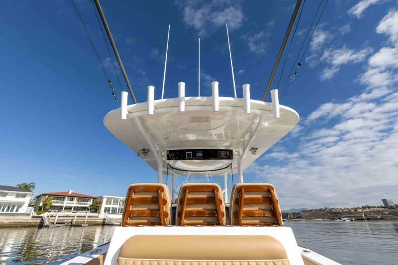 Slide: The Image of 2021 Valhalla Boatworks V37, luxury boat seats and helm, waterfront view. - 27