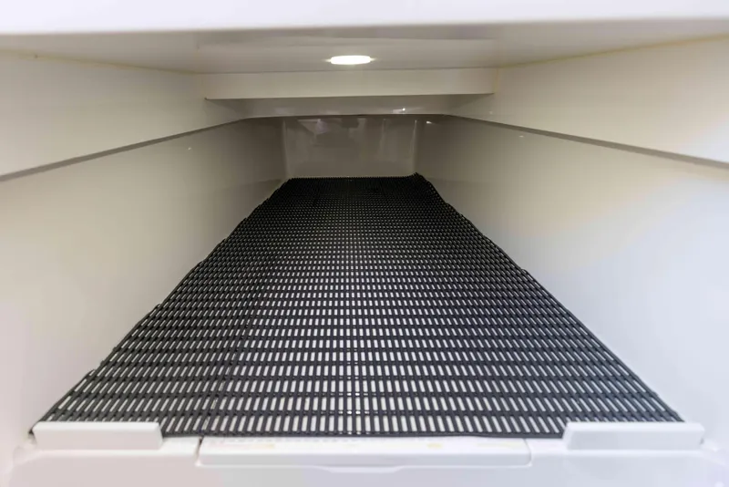 Slide: The Image of 2021 Valhalla Boatworks V37 storage compartment with black grid mat. - 28