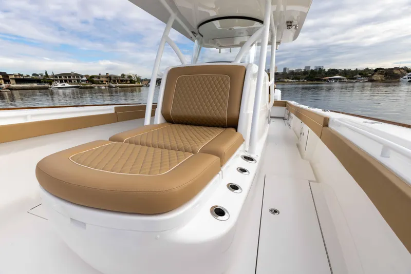 Slide: The Image of 2021 Valhalla Boatworks V37 with tan cushioned seating on deck. - 3