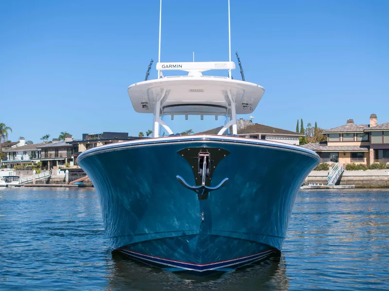 Slide: The Image of 2021 Valhalla Boatworks V37 in water, front view, docked near waterfront homes. - 34