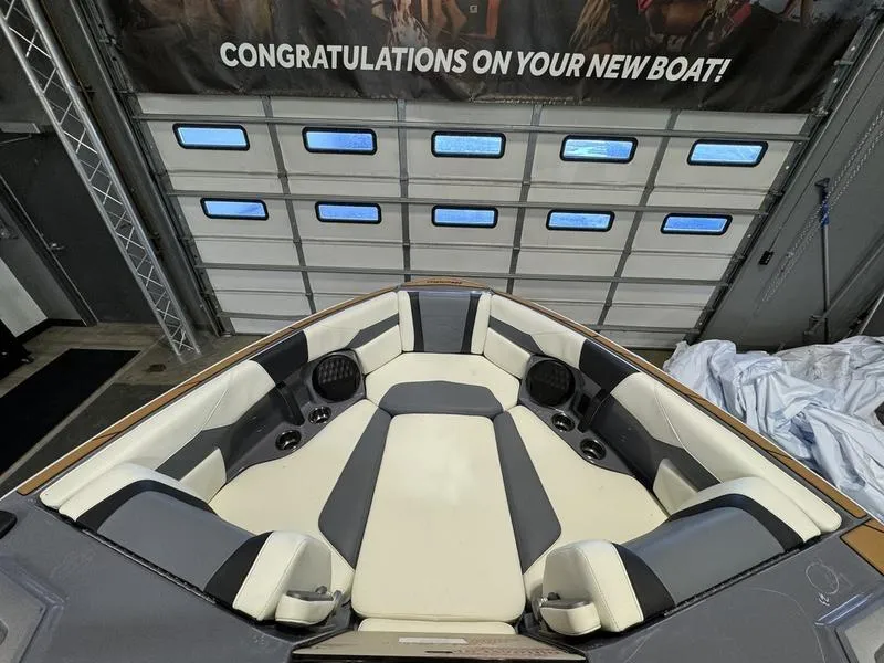 Slide: The Image of 2024 Malibu 23 LSV boat interior with luxurious seating and congratulatory banner. - 3