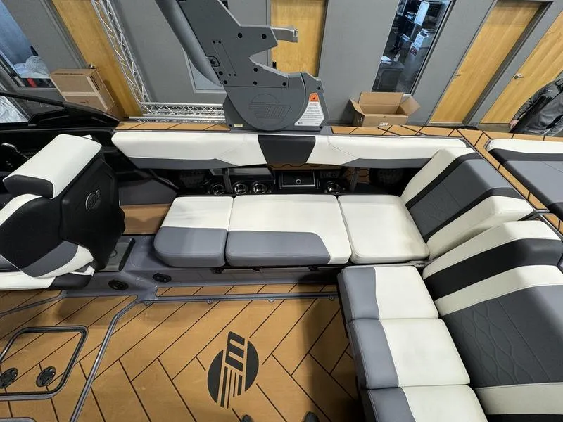 Slide: The Image of 2024 Malibu 23 LSV boat interior with white and gray seating. - 9