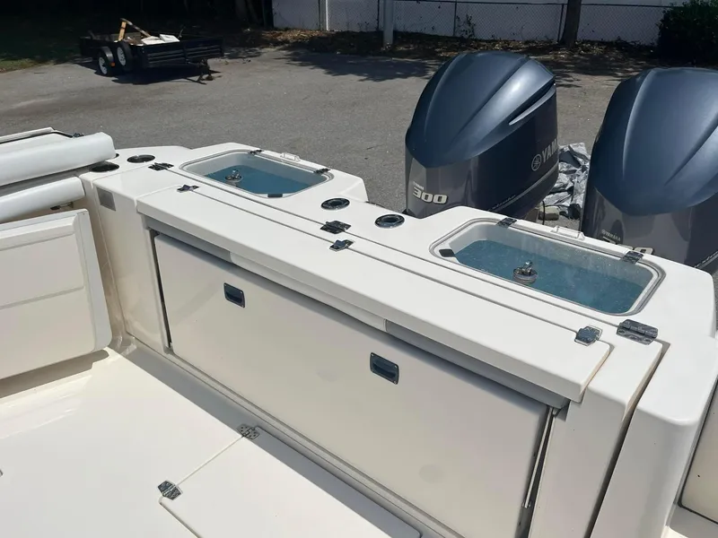 Slide: The Image of 2019 Cobia 320 CC boat with dual Yamaha 300 engines and live wells. - 12